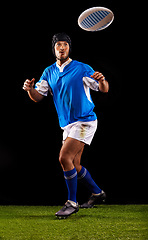 Image showing Man, ball and rugby for sport and active for game, fitness and sportswear on grass or field. Young person, athlete or player and practice in uniform for kick, competitive and fit on dark background