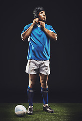 Image showing Rugby, night and background man getting ready for training, competition or sportswear in dark studio. Athlete, ball and young male person with confidence for professional sport, exercise or workout