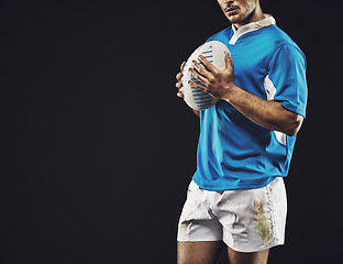 Image showing Black background, man and ball for rugby sport, closeup and mockup space, sportswear and professional for workout. Male person or player, fitness and athlete for football game or match and strong