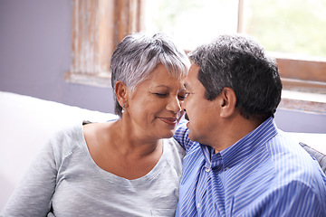 Image showing Love, sofa and elderly couple in living room with smile for love, care and embrace at home. Retirement, relax and senior people with happiness for romantic bonding, satisfaction and support in house