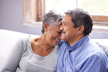 Image showing Happy, love and elderly couple on sofa with laugh for funny conversation, bonding and embrace at home. Retirement, relax and senior people with smile for joke, satisfaction and support in living room