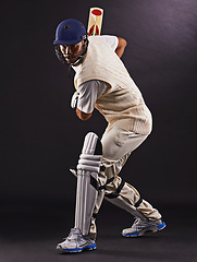 Image showing Man, cricket and athlete with sports bat in studio for professional match, competition or black background. Male person, gear and helmet with mockup space or fitness training, performance or game