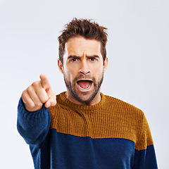 Image showing Angry man, portrait and pointing to you with scream for choice, pick or frustration on a white studio background. Frustrated male person or model yelling or shouting with mood or attitude on mockup