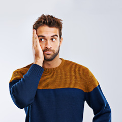 Image showing Man, thinking and worry with stress, depression or anxiety in secret on a gray studio background. Young guy, model or upset male person in mistake, disappointment or mental health on mockup space