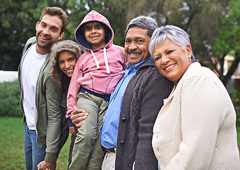 Image showing Portrait, happy and big family together in nature at garden for bonding, relationship or love at backyard. Face, park and child with parents, grandparents and mother with interracial father outdoor