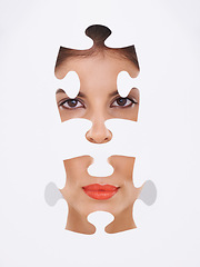 Image showing Young woman, portrait and puzzle for makeup, cosmetics and dermatology transformation on a white background. Face of a beauty model with skincare repair, solution and facial aesthetic in a studio