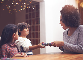 Image showing Mom, children and happy in table with gift as birthday present with smile, support and bonding. Home, family and excited together in living room for childhood memories, care for love and siblings