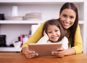 Image showing Portrait, kitchen and mother with girl, tablet and bonding together with connection and home. Face, family and mama with daughter and relax with tech and internet with social media and digital app