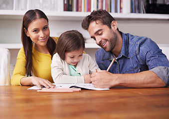 Image showing Mother, father and child at table with homework for teaching, learning and support in education with love. Writing, drawing and parents with little girl for help in homeschool, growth and development