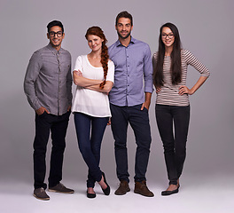 Image showing Group, people and smile in a studio portrait for creative collaboration, confidence and teamwork. Women and men or designer with arms crossed for startup career and opportunity on a gray background