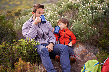 Image showing Father, child and drinking with hiking, backpack and camping with smile and support in nature. Kid, adventure and mountain with love, trust and bonding together with family and travel for holiday