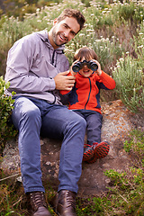 Image showing Dad, child and camping binoculars with smile from hiking, travel and watching in nature with adventure. Backpack, youth and father with love, support and trust outdoor with a smile from walking