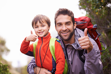 Image showing Father, child and portrait with thumbs up, backpack and travel with smile and hiking in nature. Kid, yes and mountain with love, success and bonding together with family and journey for holiday