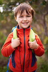 Image showing Child, smile and portrait for hiking and adventure for young and growing up for adolescent outdoor. Boy or kid with backpack and happy for trip, holiday or walk in nature for childhood and fun