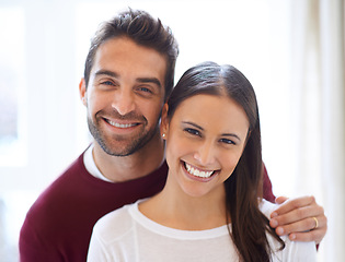 Image showing Portrait, happy couple and hug in a house with love, trust and security, support or bonding at home together. Marriage, commitment or face of people in a living room with romance, care or gratitude