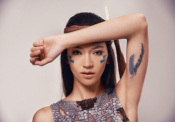 Image showing Portrait, woman and Native American girl in studio with warrior makeup, confidence and tribe style. Indigenous fashion, face paint and model in First Nations clothes on white background with culture