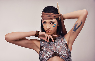 Image showing Portrait, beauty and Native American woman in studio with warrior makeup, confidence and tribe style. Indigenous fashion, face paint or girl in First Nations clothes on white background with culture