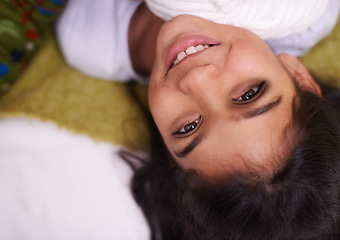 Image showing Children, portrait and Indian girl on a floor happy, curious or imagine, playful or brainstorming at home. Night, fantasy and face of kid person in living room in India with bedtime, fun or smile