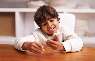 Image showing Phone, app and happy boy in a kitchen for google it, gaming or sign up at home. Smartphone, smile or Indian kid person in a house online for streaming, video or cartoon, movie or Netflix and chill