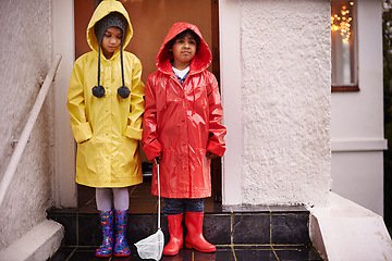 Image showing Children, raincoat and portrait on porch for unhappy, cold weather and growing up for adolescent and innocent. Kids or child with boots and upset with sibling for storm and season for holiday