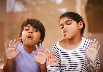 Image showing Window, face and funny siblings with kids press comic in a house with silly, joke or goofy gesture. Glass, mouth or Indian child with humor, games or playing on vacation, holiday or weekend in India