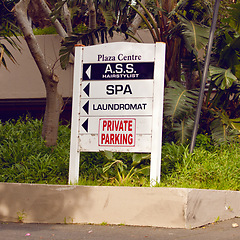 Image showing Private parking, building and sign with mall information, notification and message on property. Signage, symbol and store names on poster, board or attention for warning, direction or advertising