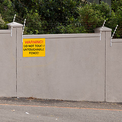 Image showing Electrical fence, warning and sign on wall of property for caution, notification and information. Public signage, symbol and building with board, poster and for attention, message and safety message