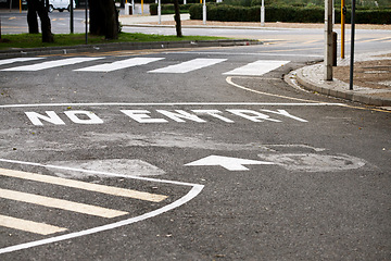 Image showing Road marking, no entry and warning with text, arrow and error for direction with paint on asphalt in city. Ground, street and mistake with language, funny typo and comic joke with symbol in Cape Town