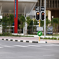 Image showing Road sign, traffic light and city with arrow for direction with travel information, typo or mistake for humor. Street, urban or metro buildings at bus stop, location and public transport in Cape Town