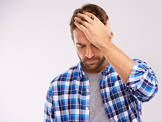 Image showing Man, hand and headache pain with fatigue stress on white background for migraine, burnout or mockup space. Male person, anxiety and brain fog tension in studio with vertigo health, wellness or dizzy