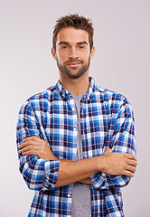 Image showing Portrait, arms crossed and man in studio for fashion isolated on a gray background. Cool person, face and confidence in casual clothes for trendy style in shirt outfit on a backdrop in Australia