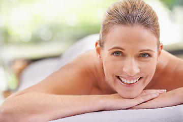 Image showing Woman, portrait and spa luxury for massage wellness at zen resort for tropical holiday, vacation or stress relief. Female person, face and smile on table or relax leisure for comfort, pamper or calm