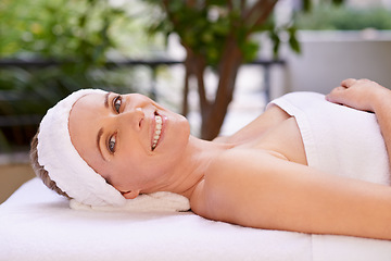 Image showing Happy woman, portrait and relax with towel for spa, zen or massage table at hotel or outdoor resort. Face of female person with smile, enjoying facial or body treatment at accommodation for wellness