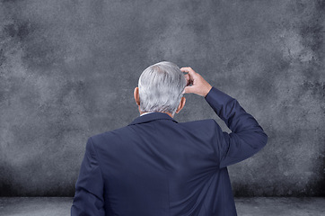 Image showing Businessman, thinking and decision with choice for selection, pick or choose on a gray studio background. Rear view of confused man, CEO or employee in wonder or thought for ideas on mockup space