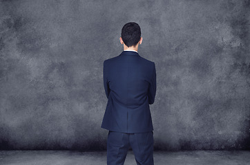 Image showing Businessman, thinking and decision with choice for ideas, selection or pick on a gray studio background. Rear view of man or employee in wonder, thought or choose for career ambition on mockup space