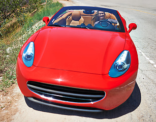 Image showing Driving, convertible and woman in car on road in city, outdoor in summer with happiness on adventure. Luxury, transport and travel with rich driver on highway or red vehicle parking on street