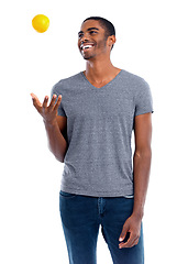 Image showing Man, lemon and fruit for healthy and fresh for diet, immune system and vitamin. African person or dietician and smile with snack and throw in air for play, detox and citrus on white background