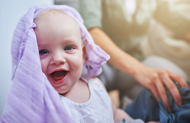 Image showing Laundry, washing and portrait of baby with clothes in home for playing, housekeeping and housework. Family, laughing and parent with happy, excited and playful newborn infant with clothing on floor