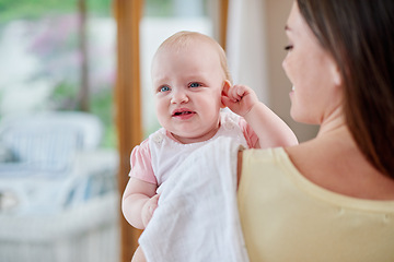 Image showing Family, home and mother carrying baby for bonding, relationship and care for motherhood. Love, parents and mom with upset newborn infant for child development, support and ear infection in house