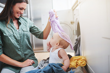 Image showing Laundry, washing and mother with baby in clothes for multitasking, housekeeping and housework. Family home, parenting and mom with newborn in basket for cleaning, playing and maintenance on floor