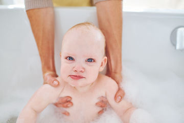 Image showing Soap, bubbles and portrait of baby in bath for cleaning, washing and hygiene with parents in home. Family, bathroom and newborn infant in bathtub, foam and water for wellness, health and childcare