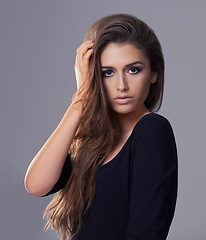 Image showing Portrait, hair care and woman with beauty, wellness and treatment on a grey studio background. Face, person and model with shampoo and keratin with confidence and cosmetics with shine and glowing