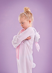 Image showing Girl, bunny and costume with attitude, studio and arms crossed for easter. Child, plush and youth with pastel, rabbit and grumpy for holiday with childhood dress up isolated on purple background