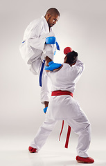 Image showing People, karate and attack with training in studio on white background to fight or practice for competition. Mma, sport and kick or respect with fitness, commitment and confidence as fighter