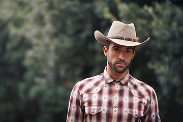 Image showing Man, portrait and outdoor cowboy fashion, western culture and countryside ranch in Texas. Male person, hat and flannel shirt for farmer aesthetic, nature and plaid style by trees or outside bush