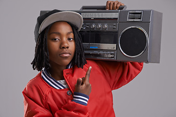 Image showing Black child, serious and portrait with radio and hand sign for hip hop, rap and swag with cool clothes in studio. Young, teen and boombox with gangster style and fashion and kid with grey background
