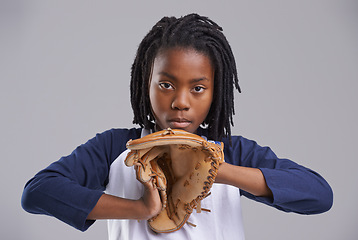 Image showing Baseball, portrait and child glove in a studio with game, sport and fitness gear with catcher of a kid. Youth and serious African boy with modern, casual and hipster fashion with a teen workout