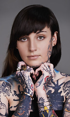 Image showing Woman, portrait and body art with tattoo for style or facial treatment on a gray studio background. Face of female person, brunette or model with design, creativity or cool artist in beauty styling