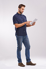 Image showing Man, tablet and scroll with internet connection in studio for website technology for connectivity, online or white background. Male person, network and digital browsing for email, streaming or mockup