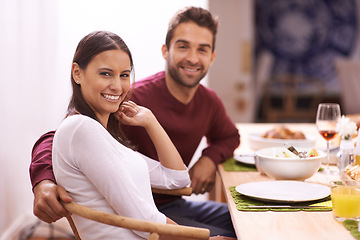 Image showing Happy couple, portrait and dining with food for dinner, romance or family meal together at home. Hungry or young man and woman with smile in relax for snack, eating or support on date by the table